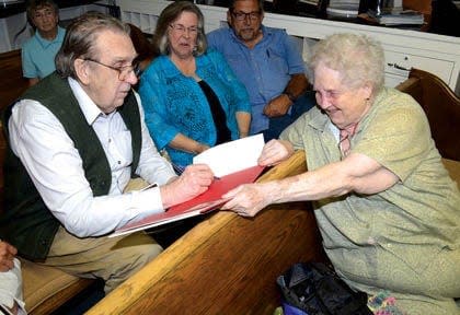 Director John Hancock, left, signs an autograph during an event in Three Oaks. Hancock will answers about his career, including directing 1989's "Prancer" in Three Oaks and New Carlisle during a holiday event in the village Nov. 26, 2022.