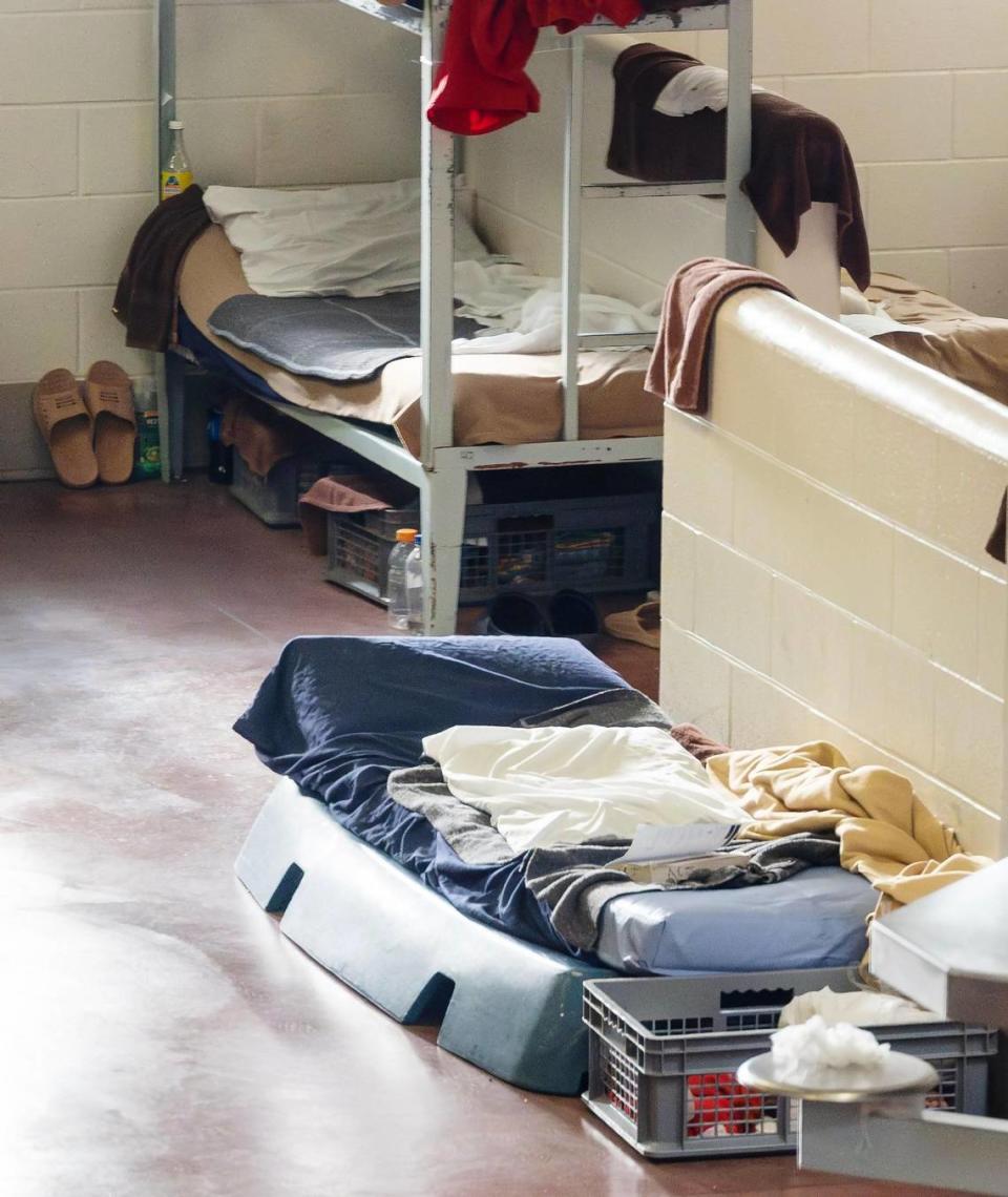 A cot-style sleeping arrangement referred to as a boat is set up on the floor of dorm 6 of Pod B. The area on Oct. 17 housed about 100 men, more than its capacity.