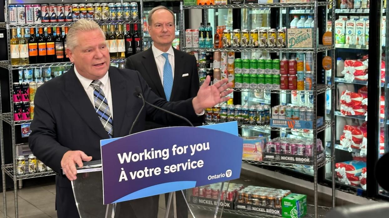 Ontario Premier Doug Ford, left, and Finance Minister Peter Bethlenfalvy announce a major expansion in the number of retail outlets that can sell beer and wine in the province at a convenience store in Toronto. (Mike Crawley/CBC - image credit)