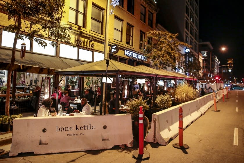 Pasadena, CA, Tuesday, December 1, 2020 - Diners eat outside on Raymond Ave. in Pasadena despite an LA County order forbidding it. Pasadena restaurants, including Bone Kettle would have 48 hours to respect a statewide ban that was issued later that night. (Robert Gauthier/ Los Angeles Times)