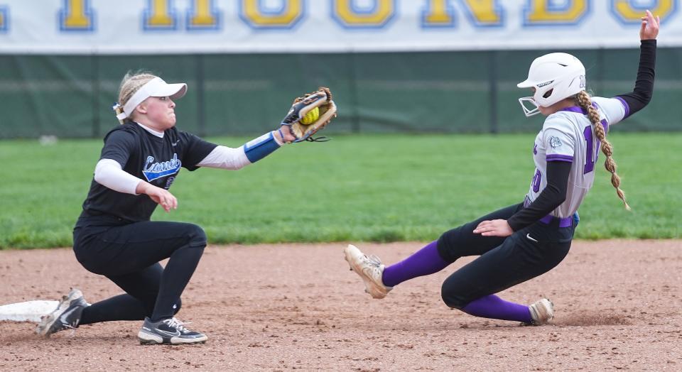 Brownsburg Izzy Neal (10) slides into second base against Carmel Lily Sullivan (23) on Saturday, April 22, 2023 at Cherry Tree Softball Complex in Carmel. 