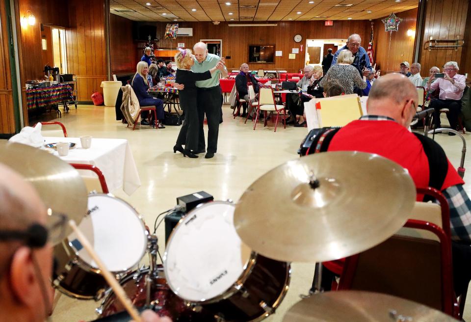 Frances Kubalak dances with friends as a polka band plays during her 102nd birthday party at the Polish American Citizens Club on Dec. 8 in Akron. She is wearing her trademark high heels.