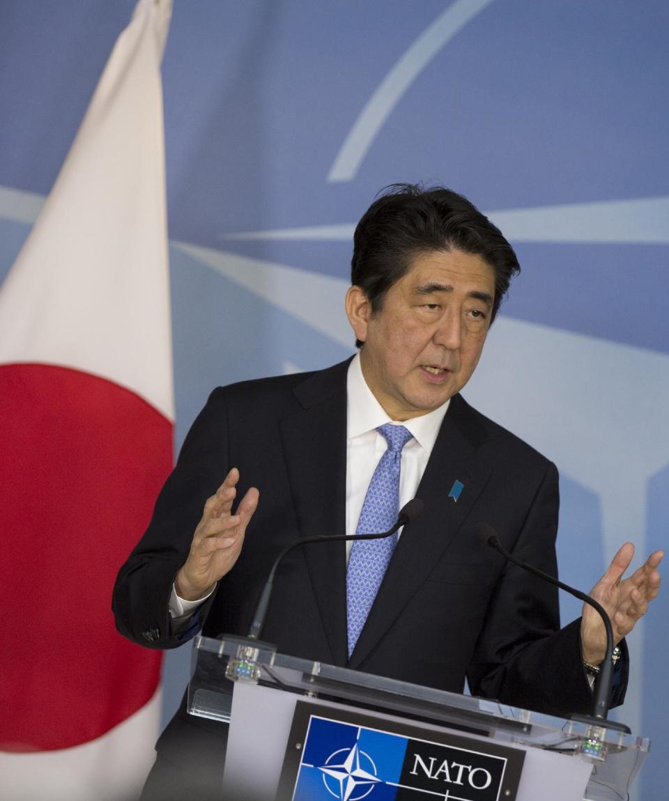 Japan's Prime Minister Shinzo Abe speaks during a media conference at NATO headquarters in Brussels on Tuesday, May 6, 2014. Abe will, in a two-day visit, meet with NATO, EU and Belgian officials. (AP Photo/Virginia Mayo)