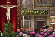 A survivor of sex abuse, who wished to remain anonymous, background right, plays violin after he delivered his testimony during a penitential liturgy attended by Pope Francis at the Vatican, Saturday, Feb. 23, 2019. The pontiff is hosting a four-day summit on preventing clergy sexual abuse, a high-stakes meeting designed to impress on Catholic bishops around the world that the problem is global and that there are consequences if they cover it up. (Vincenzo Pinto/Pool Photo Via AP)