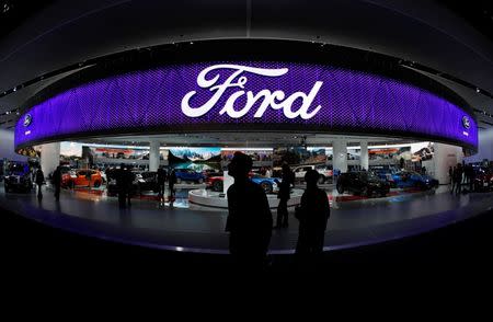 People walk by the Ford display during the North American International Auto Show in Detroit, Michigan, U.S., January 10, 2017. REUTERS/Mark Blinch