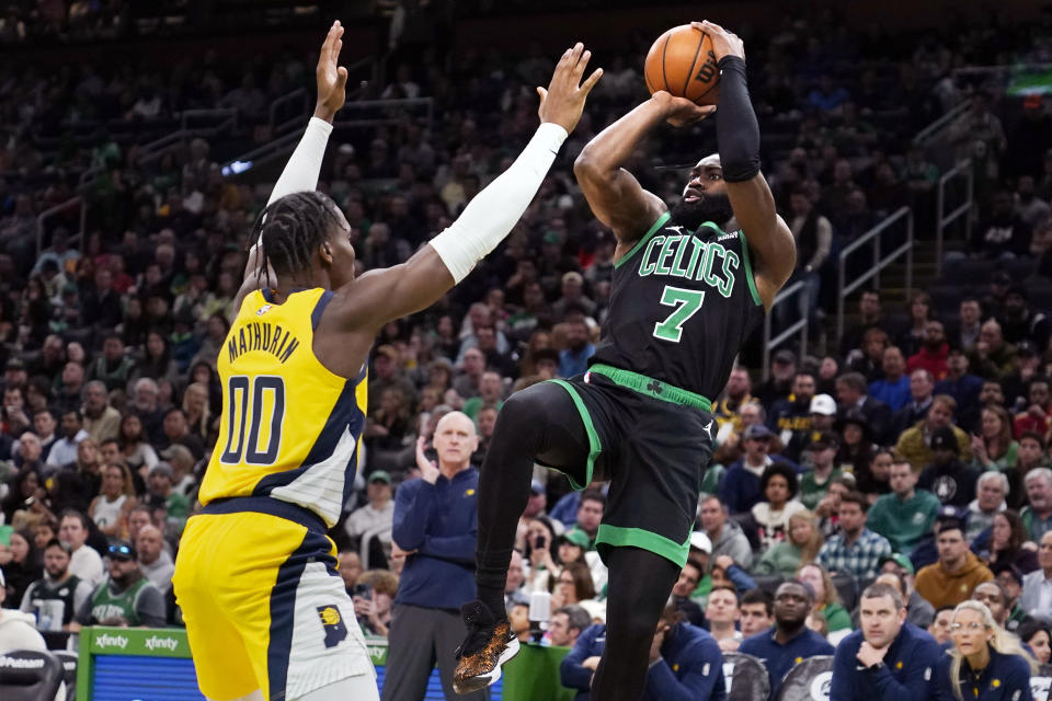 Boston Celtics guard Jaylen Brown (7) shoots over Indiana Pacers guard Bennedict Mathurin (00) during the second half of an NBA basketball game Wednesday, Nov. 1, 2023, in Boston. (AP Photo/Charles Krupa)