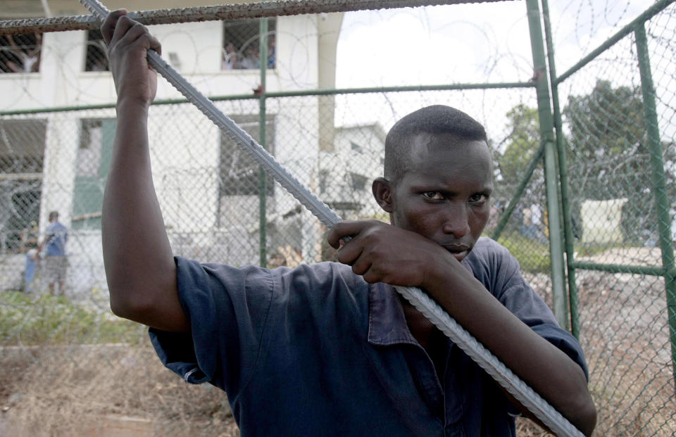 A Somali inmate detained in an anti-piracy operation conducted by Seychelles Coast Guard, pauses as he works at the incarceration block in Montagne Posee near Victoria, Seychelles, Friday, March 2, 2012. (AP Photo/Gregorio Borgia)