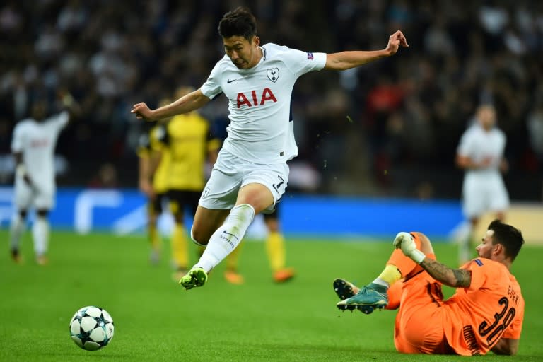 Tottenham Hotspur's striker Son Heung-Min (L) takes the ball past Borussia Dortmund's goalkeeper Roman Buerki (R) during the UEFA Champions League on September 13, 2017