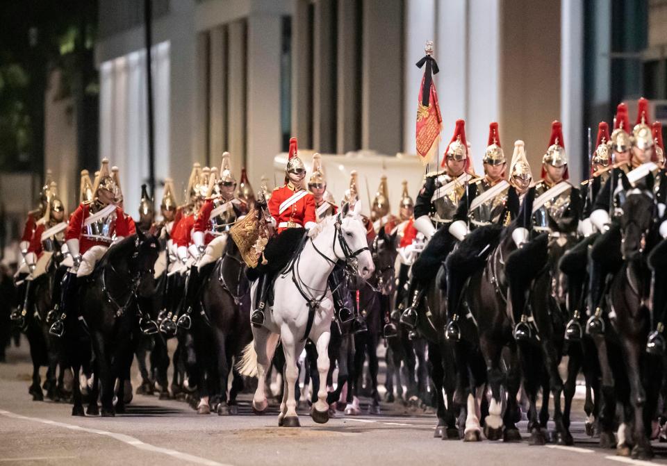 Horses and riders process in central London (PA)