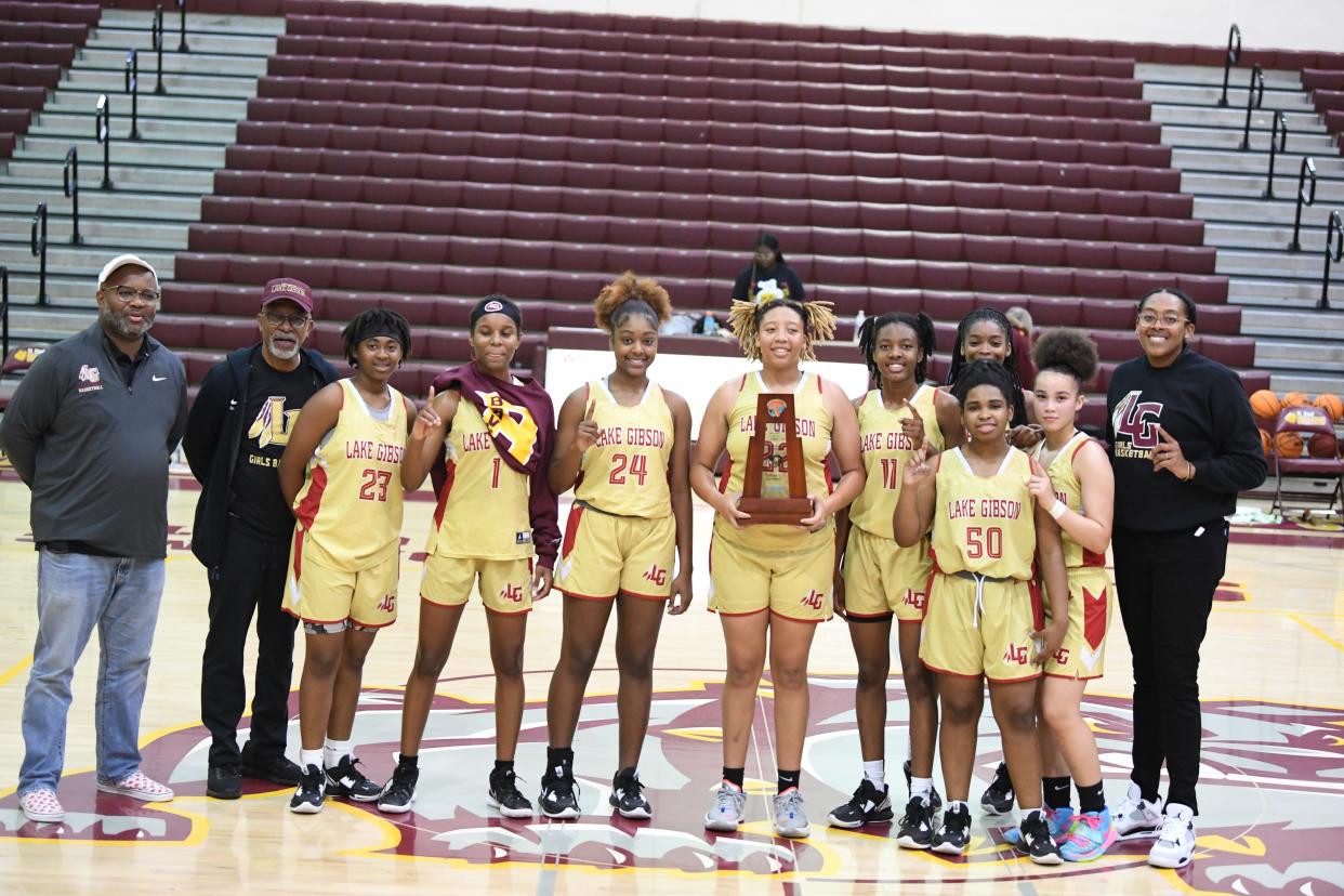 Lake Gibson won its fourth district title game in eight years after defeating No. 1 seed St. Cloud on Friday, Feb. 3, 2023, at St. Cloud High School. From left to right are the following: Coach Marquis Roberts, Mr. Terry Coney (stats), Jakhia Willis, Taniya Brown, Camryn Wiggins, Samari Wilson, Jamila Ray, Kamryn Veasy (No. 50), Talea Turner, Deondrea Arrington and Coach Antonia Bennett.