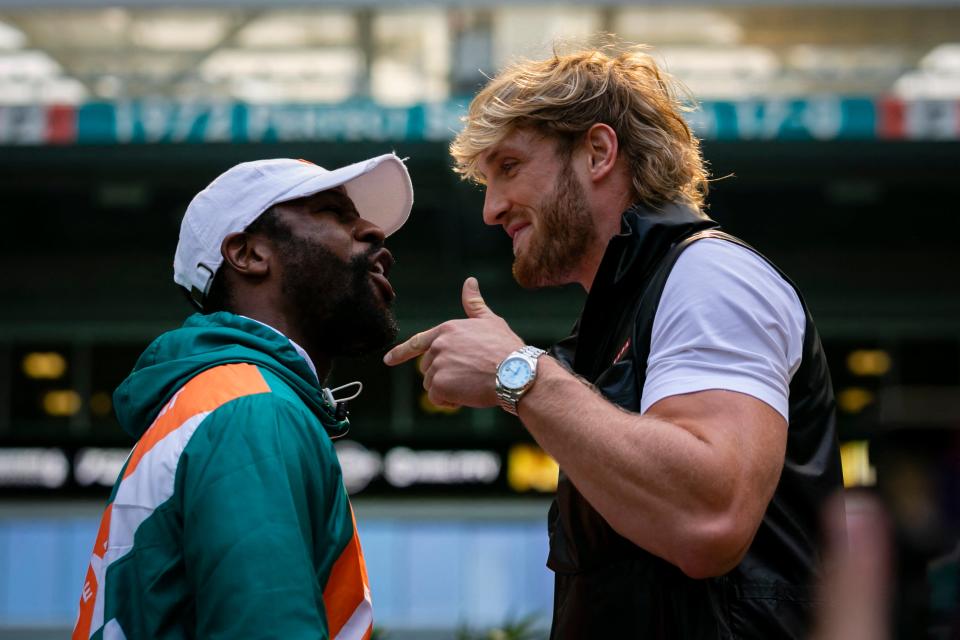 <p>Floyd Mayweather and Logan Paul square up at a recent promotional event</p> (AFP via Getty Images)