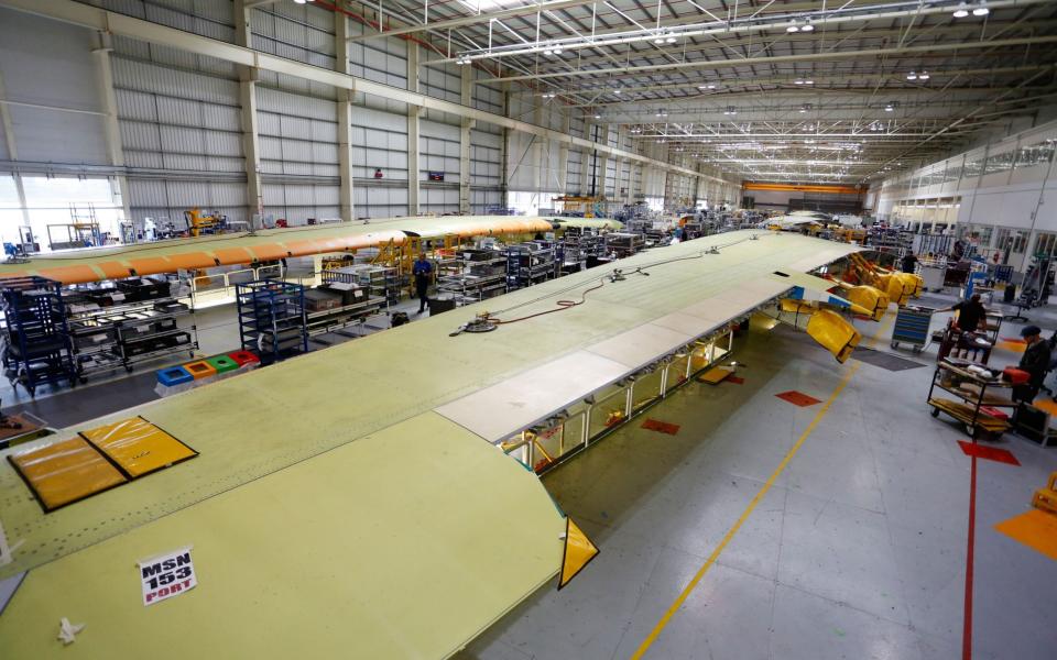 Employees work on Airbus A380 wings on the assembly production line at the Airbus SAS factory in Broughton, UK - Paul Thomas/Bloomberg