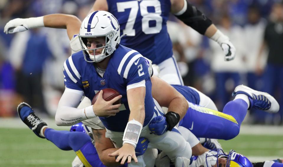 Indianapolis Colts quarterback Carson Wentz (2) is sacked by Los Angeles Rams defensive tackle Greg Gaines (91) and Los Angeles Rams safety Taylor Rapp (24) on Sunday, Sept. 19, 2021, during a game against the Los Angeles Rams at Lucas Oil Stadium in Indianapolis.