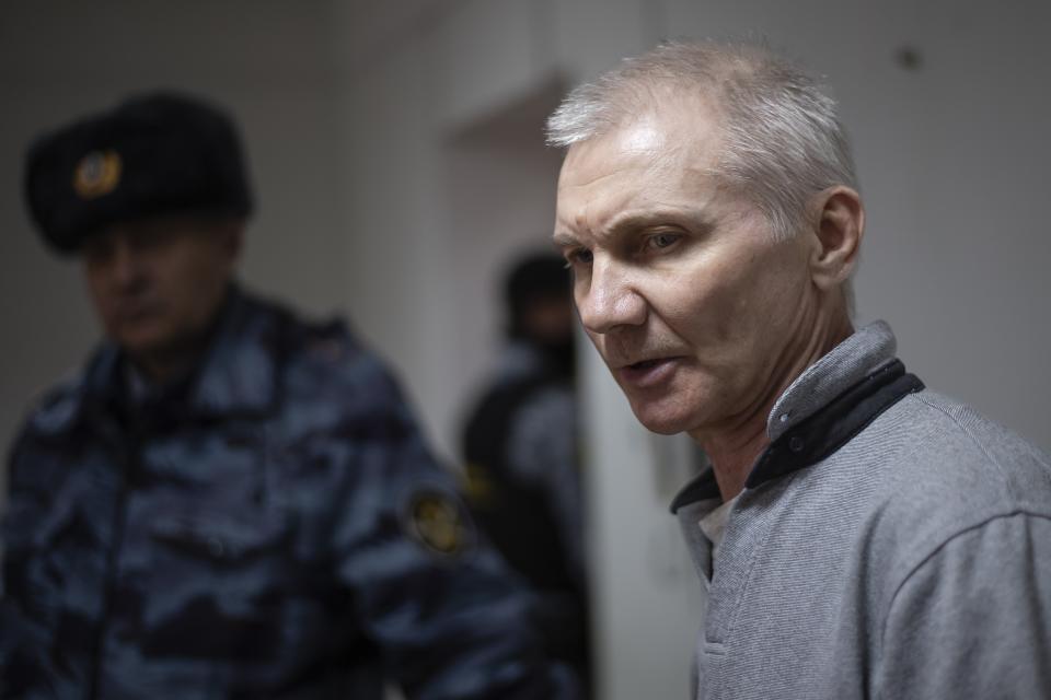 Alexei Moskalyov, right, is escorted from a courtroom in Yefremov, Tula region, some 300 kilometers (186 miles) south of Moscow, Russia, Monday, March 27, 2023. A court in Russia on Tuesday convicted a single father over social media posts criticizing the war in Ukraine and sentenced him to two years in prison — a case brought to the attention of authorities by his daughter's drawings against the invasion at school, according to the man's lawyer and local activists. The 54-year-old Moskalyov, a single father of a 13-year-old daughter, was accused of repeatedly discrediting the Russian army, a criminal offense in accordance to a law Russian authorities adopted shortly after sending troops into Ukraine. (AP Photo)