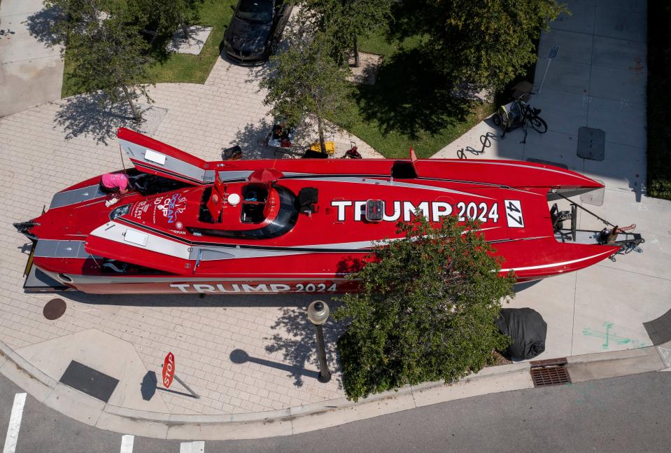 A crew prepares the 52-foot Mystic catamaran emblazoned with Trump 2024 parked outside race headquarters at the Ben hotel on June 7, 2024 in West Palm Beach, Florida. Roger Norman and Nigel Cook will pilot the boat during the Ocean Cup 2024. The 128-mile race from Palm Beach to West End, Bahamas and back is Saturday.