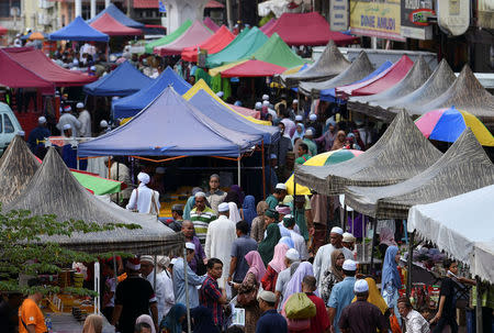 People buy groceries after attending a 'ceramah' or religious lecture at Kota Bharu in Kelantan, Malaysia April 13, 2018. REUTERS/Stringer