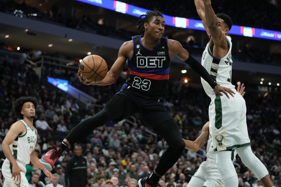 Detroit Pistons' Jaden Ivey looks to pass around Milwaukee Bucks' Giannis Antetokounmpo during the first half of an NBA basketball game Wednesday, Nov. 2, 2022, in Milwaukee. (AP Photo/Morry Gash)