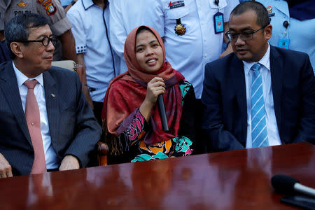 Siti Aisyah, who was previously a suspect in the murder case of North Korean leader's half brother Kim Jong Nam talks during a news conference with Indonesia's Law and Human Rights Minister Yasona Laoly, after a Malaysian court released her of charges at Halim Perdanakusuma airport in Jakarta, Indonesia, March 11, 2019. REUTERS/Willy Kurniawan