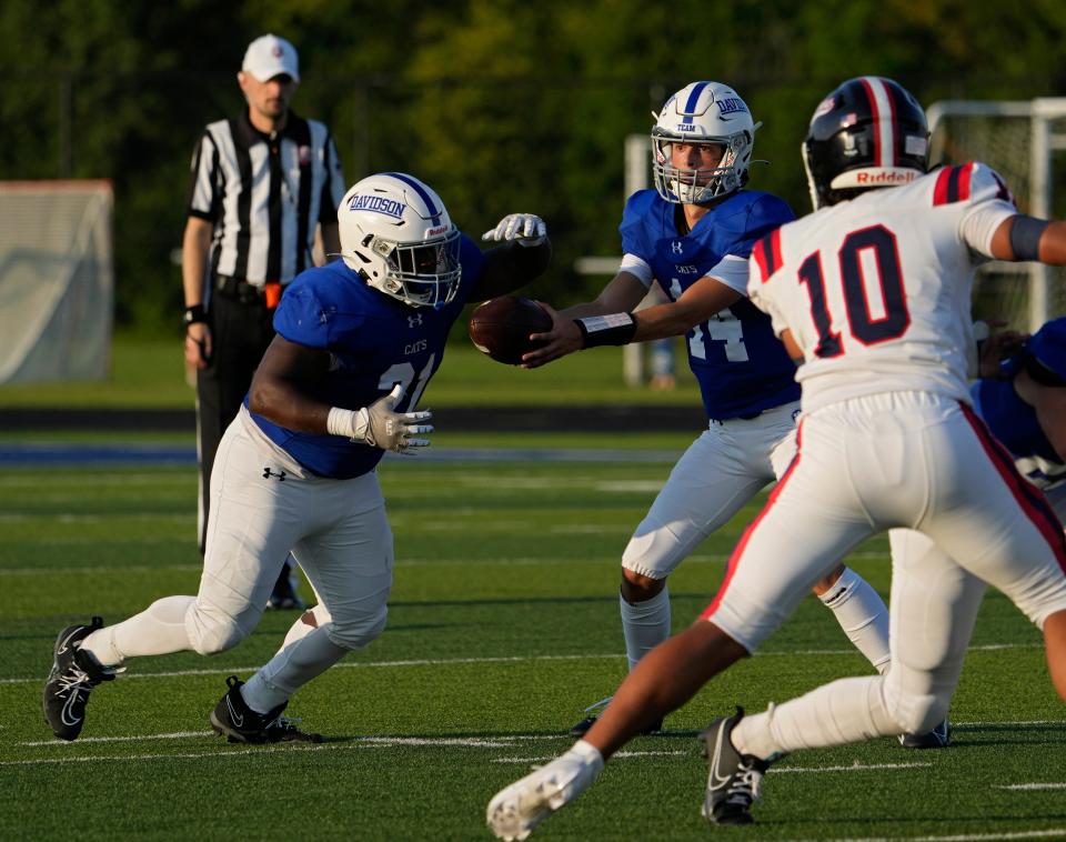 Hilliard Davidson quarterback Johnny DiBlasio hands off to Keevin Gibbon on Aug. 25 against Grove City.