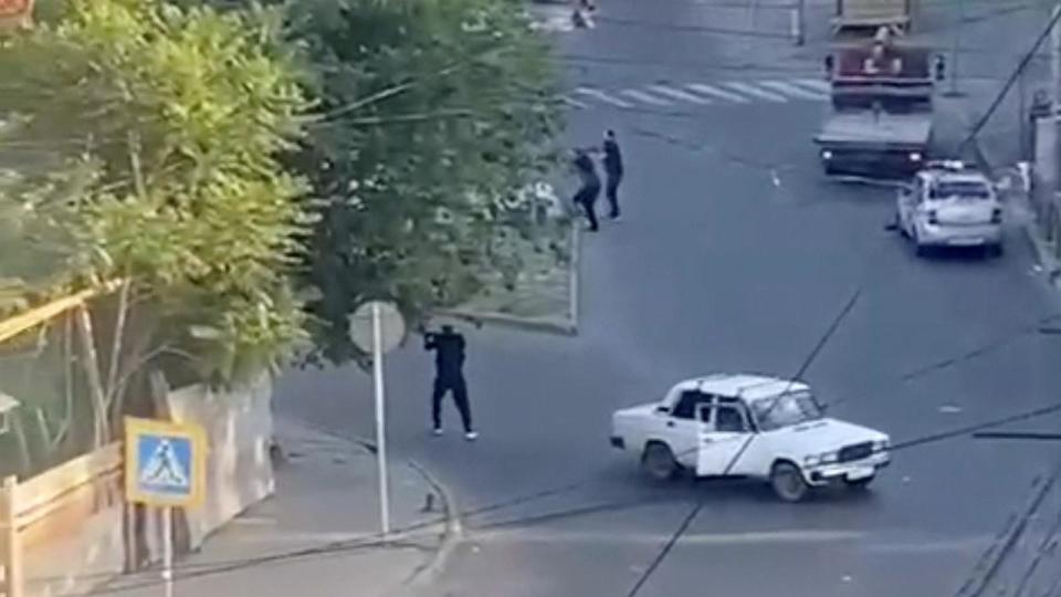 PHOTO: A view shows a shooting scene on the street of Makhachkala in southern Russia, June 23, 2024, in this still image obtained from a video.  (Obtained By Reuters/via Reuters)