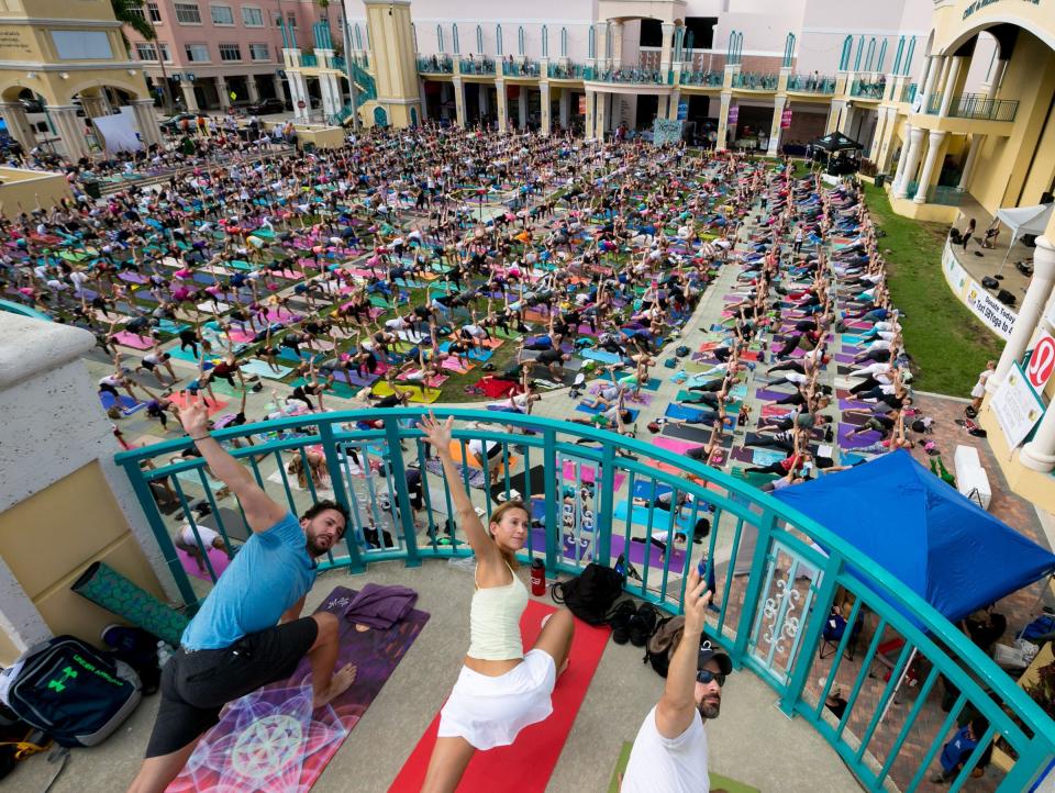 More than 1,000 people participate during a free community yoga gathering in the Mizner Park Amphitheater in December 2018.