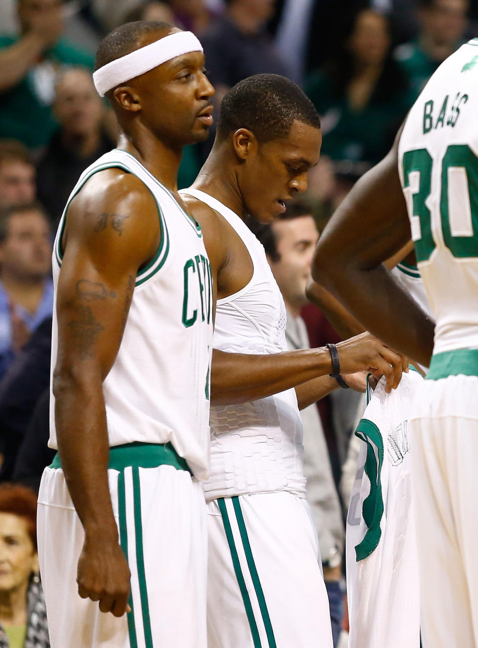 BOSTON, MA - NOVEMBER 28: Rajon Rondo #9 of the Boston Celtics puts on a new jersey after his was ripped off after getting into a fight with Kris Humphries #43 of the Brooklyn Nets during the game after Garnett was fouled on a play on November 28, 2012 at TD Garden in Boston, Massachusetts. Rajon Rondo and Kris Humphries would each be ejected from the game immediately following the fight.