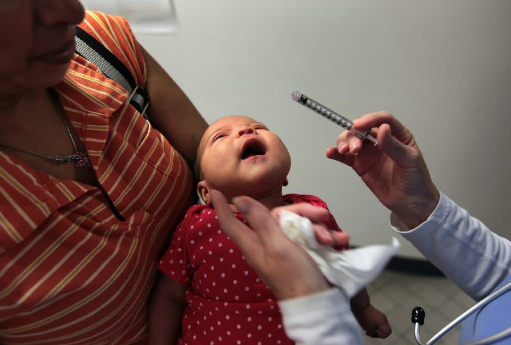 Two-month-old Karina, the child of uninsured parents, receives drops of children’s Tylenol after getting a vaccination at a low-cost clinic run by the Rocky Mountain Youth Clinics on July 28, 2009, in Aurora, Colorado. Funded primarily through donations and grants, Rocky Mountain Youth Clinics treats mostly children of uninsured parents, those on Medicaid and others whose parents cannot afford to pay the high deductibles charged by many health insurance policies. (John Moore/Getty Images)