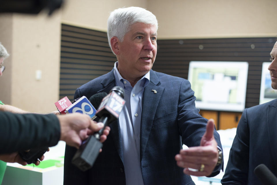 FILE - In this July 24, 2018 file photo, Gov. Rick Snyder answers questions after a press conference in Portage, Mich. Snyder has signed Republican-backed laws to significantly scale back citizen-initiated measures to raise the minimum wage and require paid sick leave for workers. The term-limited Republican governor's move Friday, Dec. 14, 2018, is sure to prompt a lawsuit over an unprecedented strategy adopted by lame-duck lawmakers. (Daniel Vasta/Kalamazoo Gazette via AP File)
