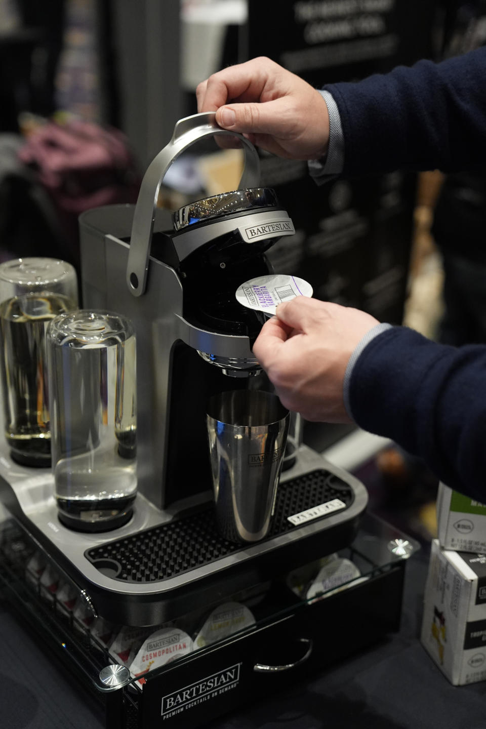 A person demonstrates the Bartesian Premier connected intelligent cocktail maker at the Bartesian booth at Pepcom ahead of the CES tech show Monday, Jan. 8, 2024, in Las Vegas. (AP Photo/John Locher)