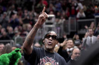 Former Chicago Bulls' Dennis Rodman acknowledges the crowd as they chant his name as he makes a courtside appearance before an NBA basketball game between the Bulls and the Washington Wizards, Saturday, March 16, 2024, in Chicago. (AP Photo/Charles Rex Arbogast)