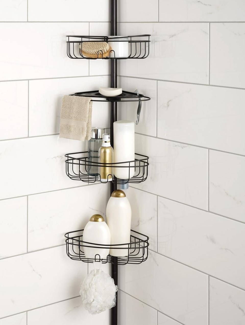 the shower caddy in the corner of a shower with multiple shelves