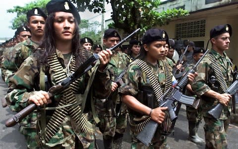 Guerrillas of the Marxist Revolutionary Armed Forces of Colombia (FARC) march in a military parade amid international pressure for dialogue  - Credit: AFP 