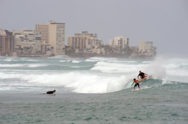 Surfers ride southshore swells generated by Lane on Waikiki Beach, Hawaii