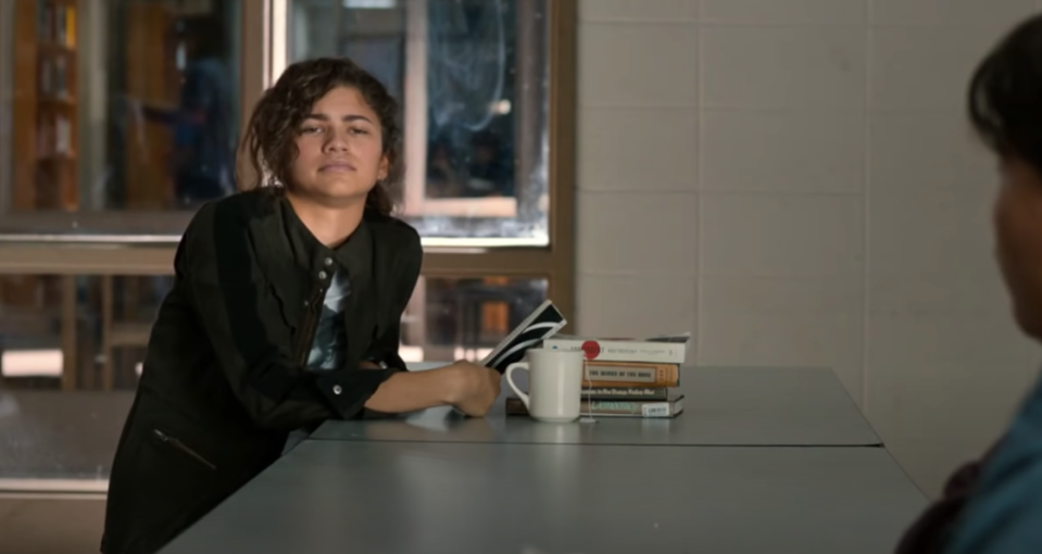 Michelle reading in the school cafeteria