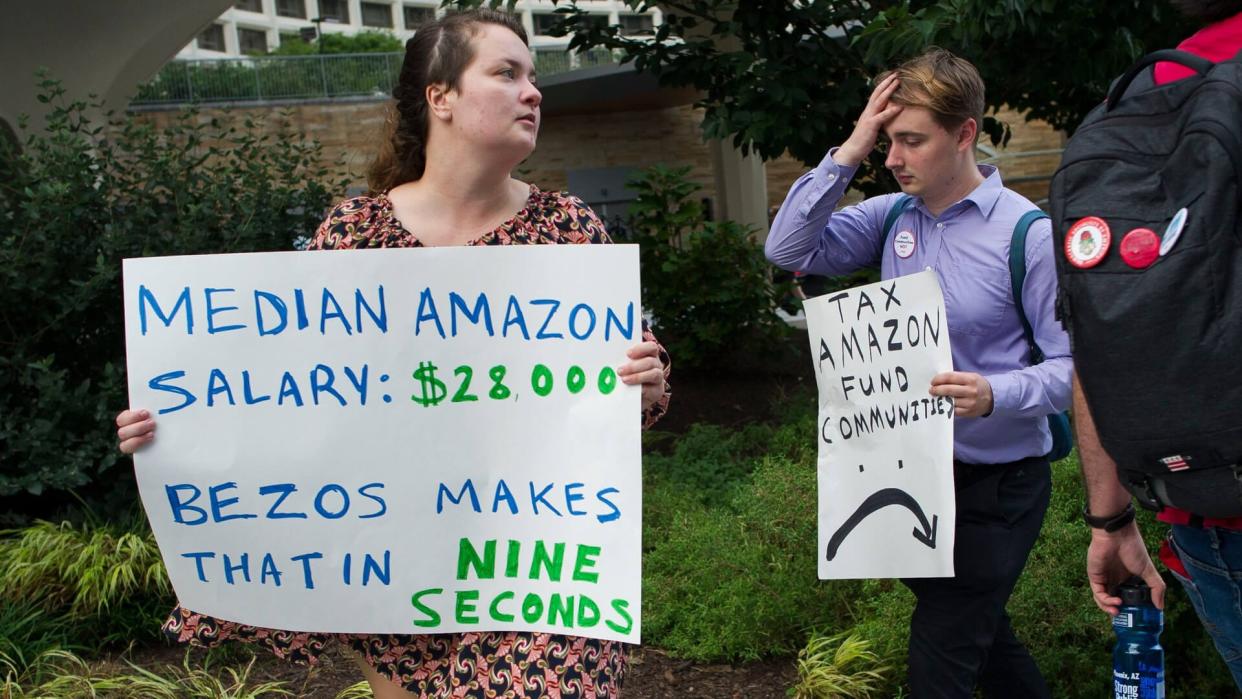 Mandatory Credit: Photo by Cliff Owen/AP/Shutterstock (9881640b)Demonstrators protest against Amazon and Jeff Bezos, Amazon founder and CEO, outside of the hotel where the Economic Club of Washington is having their Milestone Celebration in Washington, .