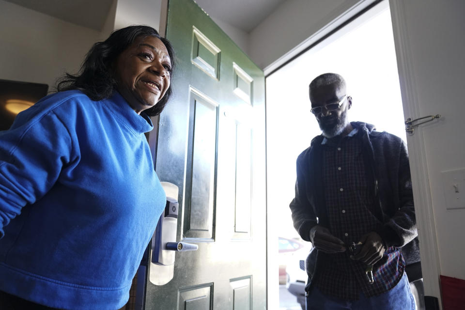 Faye Moore opens the door for her partner Garry Betared at the hotel room they are staying in on Wednesday, Nov. 24, 2021, in Morrow, Ga. Moore contends she was illegally evicted from her two-bedroom townhouse in an Atlanta suburb. (AP Photo/Brynn Anderson)