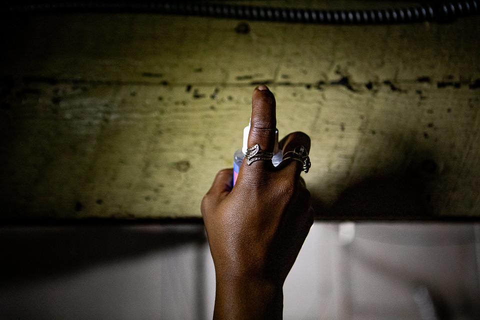 Kwmisha Adams applies a lead paint testing spray to a support beam in the basement of her residence on Lindell Avenue in Louisville's Shawnee neighborhood. The house was built in the 1920s and had tested positive for lead paint in other rooms. Adams is concerned about exposure to lead affecting her five children. Oct. 10, 2023