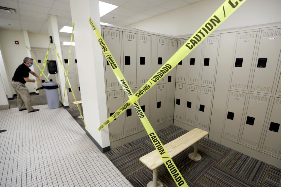 FILE - In this May 1, 2020, file photo, locker rooms are marked off so they cannot be used at the Dickson County Family YMCA in Dickson, Tenn. Friday is the first day that gyms can reopen with some restrictions during the coronavirus pandemic in select counties in Tennessee. (AP Photo/Mark Humphrey, File)