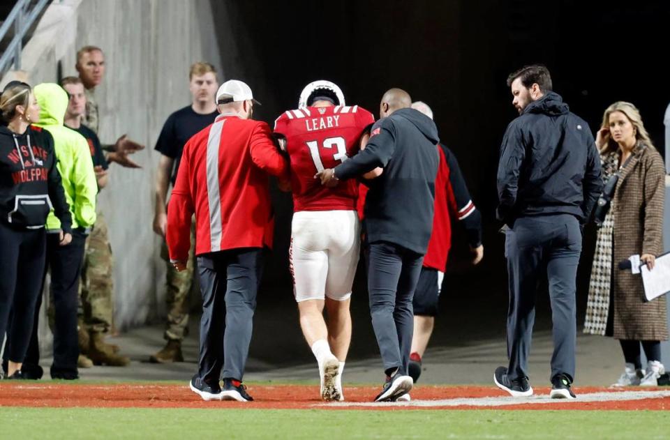 N.C. State quarterback Devin Leary (13) is helped off the field after being injured during the second half of N.C. State’s game against Florida State at Carter-Finley Stadium in Raleigh, N.C., Saturday, Oct. 8, 2022.