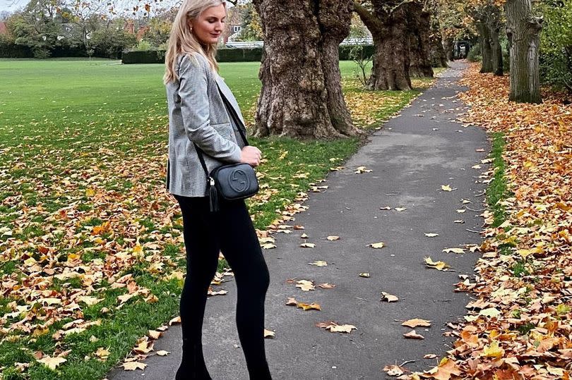 A woman stood in a park in heels