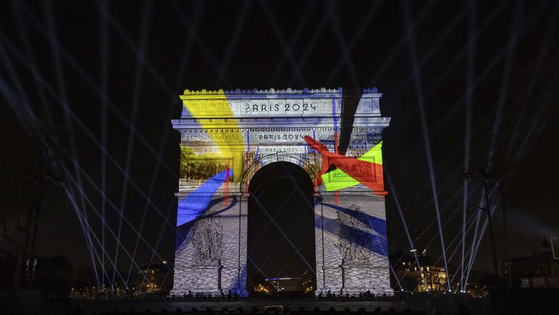 A video mapping is projected on the Arc de Triomphe to celebrate France’s entry into the Olympic year, during New Year celebrations on the Champs Elysees in Paris, France, on Dec. 31, 2023.