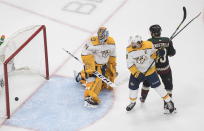 Nashville Predators goalie Juuse Saros (74) is scored on as Arizona Coyotes' Brad Richardson (15) and Predators' Filip Forsberg (9) battle in front of the net during first period NHL hockey action in Edmonton, Alberta, Friday, Aug. 7, 2020. (Jason Franson/The Canadian Press via AP)