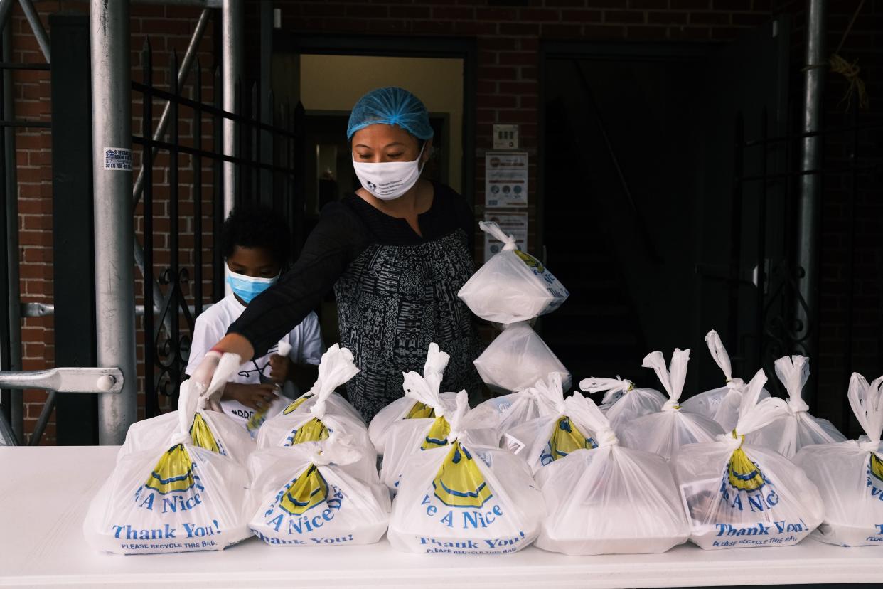 Meals are prepared and placed on an outdoor table for people to receive at the Thessalonica Christian Church during a distribution on Oct. 22, 2020 in New York City. The Bronx has been especially impacted by the COVID-19 pandemic, with the official unemployment rate in the borough at approximately 21%, while the unofficial number is presumed to be almost twice that.