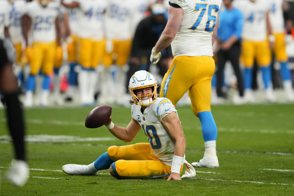 Los Angeles Chargers quarterback Justin Herbert (10) reacts after being tackled during the first half of an NFL football game against the Las Vegas Raiders, Sunday, Dec. 4, 2022, in Las Vegas. (AP Photo/Matt York)