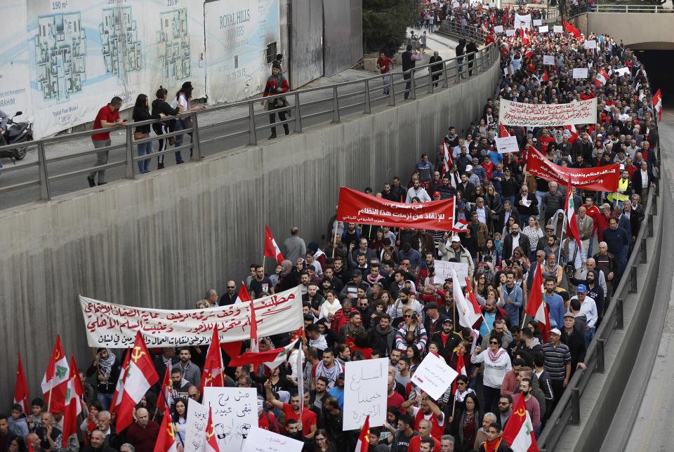 Demonstrators march during a protest against the government organized by the country's communist party, in Beirut, Lebanon, Sunday, Dec. 16, 2018. Hundreds of Lebanese called for an end to a stalemate over forming a government seven months after elections. The Sunday protests were organized by the country's vibrant communist party, but drew others frustrated by the country's deepening economic and political crisis. (AP Photo/Hussein Malla)