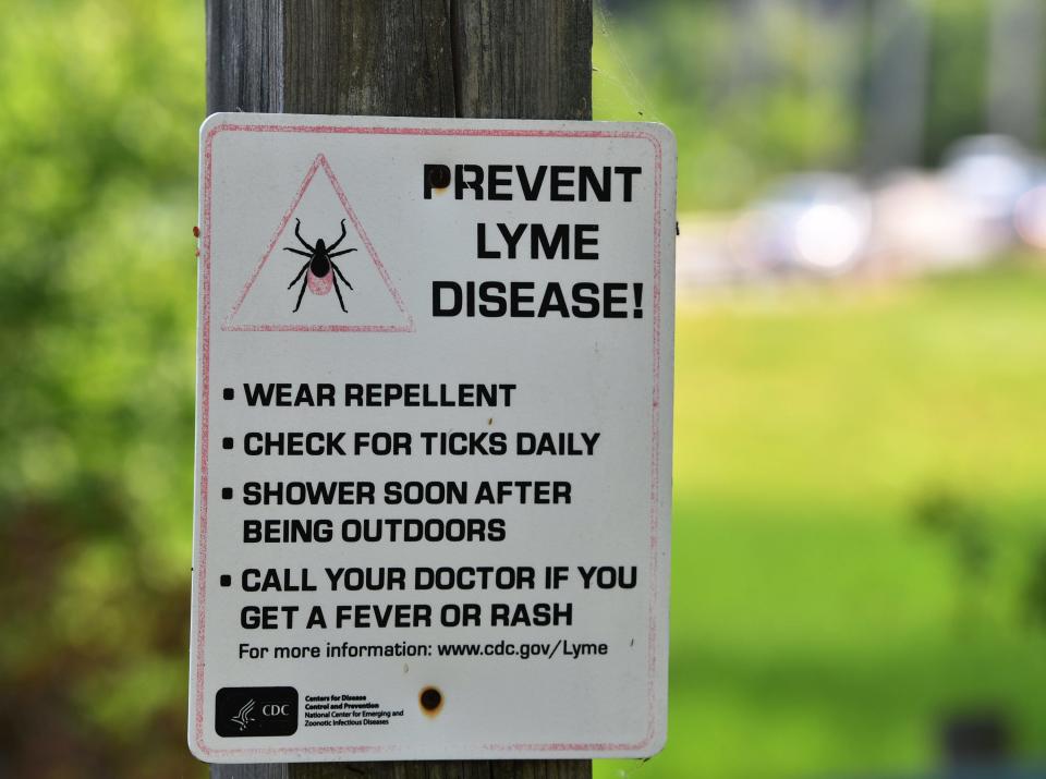 Tick signage outside a rail trail in West Boylston, Massachusetts. [T&G Staff/Christine Peterson]