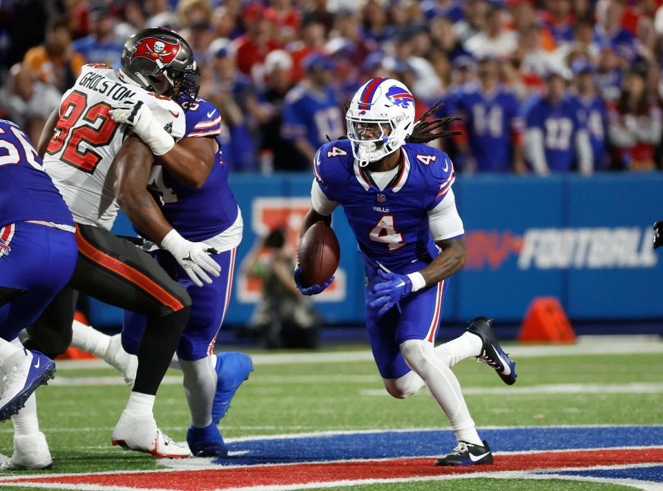 Buffalo Bills running back James Cook (4) looks for running room.