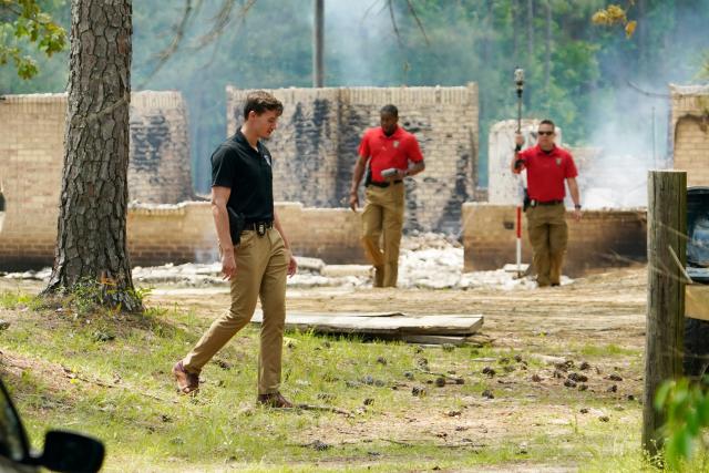 Investigators inspect search around the remnants of a burned out house where authorities believe a man who escaped from a Mississippi jail over the weekend with three others, and is suspected of killing a pastor, is believed to be dead after a shootout with authorities and barricaded himself inside a burning home near Conway, Mississippi, Wednesday morning, April 26, 2023 (AP)