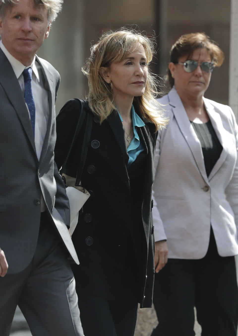 Actress Felicity Huffman arrives at federal court in Boston on Wednesday, April 3, 2019, to face charges in a nationwide college admissions bribery scandal. (AP Photo/Charles Krupa)