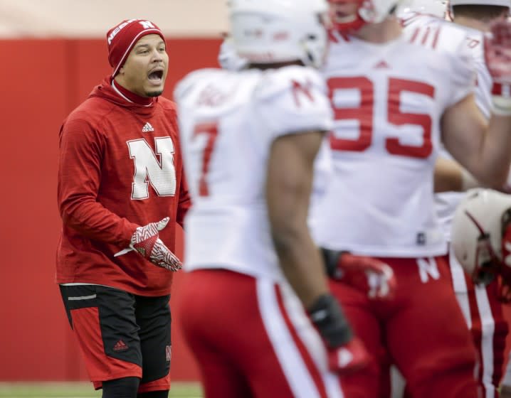 Cornerbacks coach Donte Williams works with players during NCAA college football.